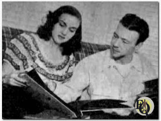 Howard Culver (R) and his wife Mimi (L) going over some photographs (1947)