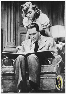 A scene from the 1942 stage play "Claudia" includes Donald Cook and Dorothy McGuire.