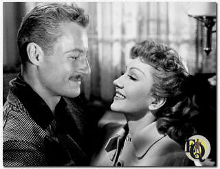 Man en vrouw... Het leven is mooi voor Claudette Colbert en Richard Derr, die net in het huwelijksbootje zijn gestapt in Metro-Goldwyn-Mayer's "The Secret Heart", het romantische spanningsdrama van een familie die voortdurend bang is voor het verleden . Miss Colbert schittert naast Walter Pidgeon en June Allyson, verder ook met Robert Sterling, Marshall Thompson en Patricia Medina. Robert Z. Leonard regisseerde, Edwin Knopf produceerde voor M-G-M.