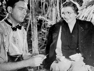 Stewart Corder (William Gargan) met schooljuf Judy Jones (Claudette Colbert) in "Four Frightened People" (1934).