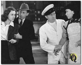 Charles Lane (as Doc Prouty) holding back Margaret Lindsay (L) in "Ellery Queen's Penthouse Mystery" (1941)