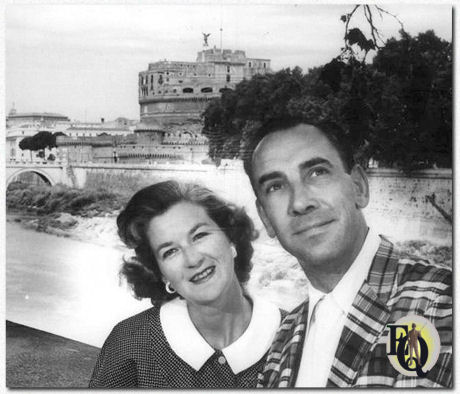 Television Announcer Rex Marshall and wife doing some sighseeing in Rome. Backgrounding them from beyond the Tiber River is the famed Castel St. Angelo (July 11. 1955)