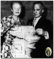 Ann Harding and executive producer Albert McCleery of the NBC Matinee Theater, look over a birthday cake of scripts used in the series, which has now passed its 100th program mark. Miss Harding will be see in the color-drama.