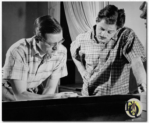 Lyn Murray (left), composer, conductor and arranger, at work with Norman Corwin on the musical score for "Columbia Presents Corwin", the new series starting March 7. 1944 over the CBS network. First broadcast of the series is "Movie Primer".