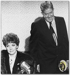 FLEETING SMILE -- Rudy Vallee, as top songwriter, is all smiles as he joins his wife (Polly Bergen) in what proves to be his final radio interview in "Ellery Queen" episode "The Tyrant of Tin Pan Alley".